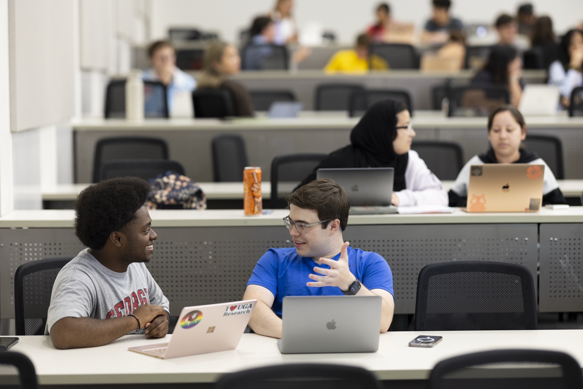 UGA students using laptops in a collaborative classroom setting